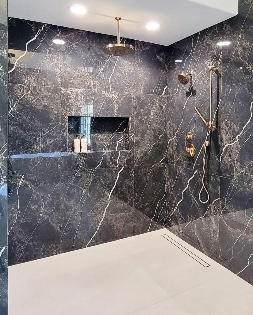 Stunning Bathroom with Black Marble Walls and Luxurious Golden Appliances and Accessories - Elegant Home Renovation and Remodeling Design.