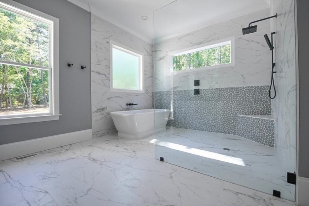 Exquisite Bathroom Renovation with White Marble Walls and Flooring - Luxury Home Remodeling and General Contracting Services in Seattle